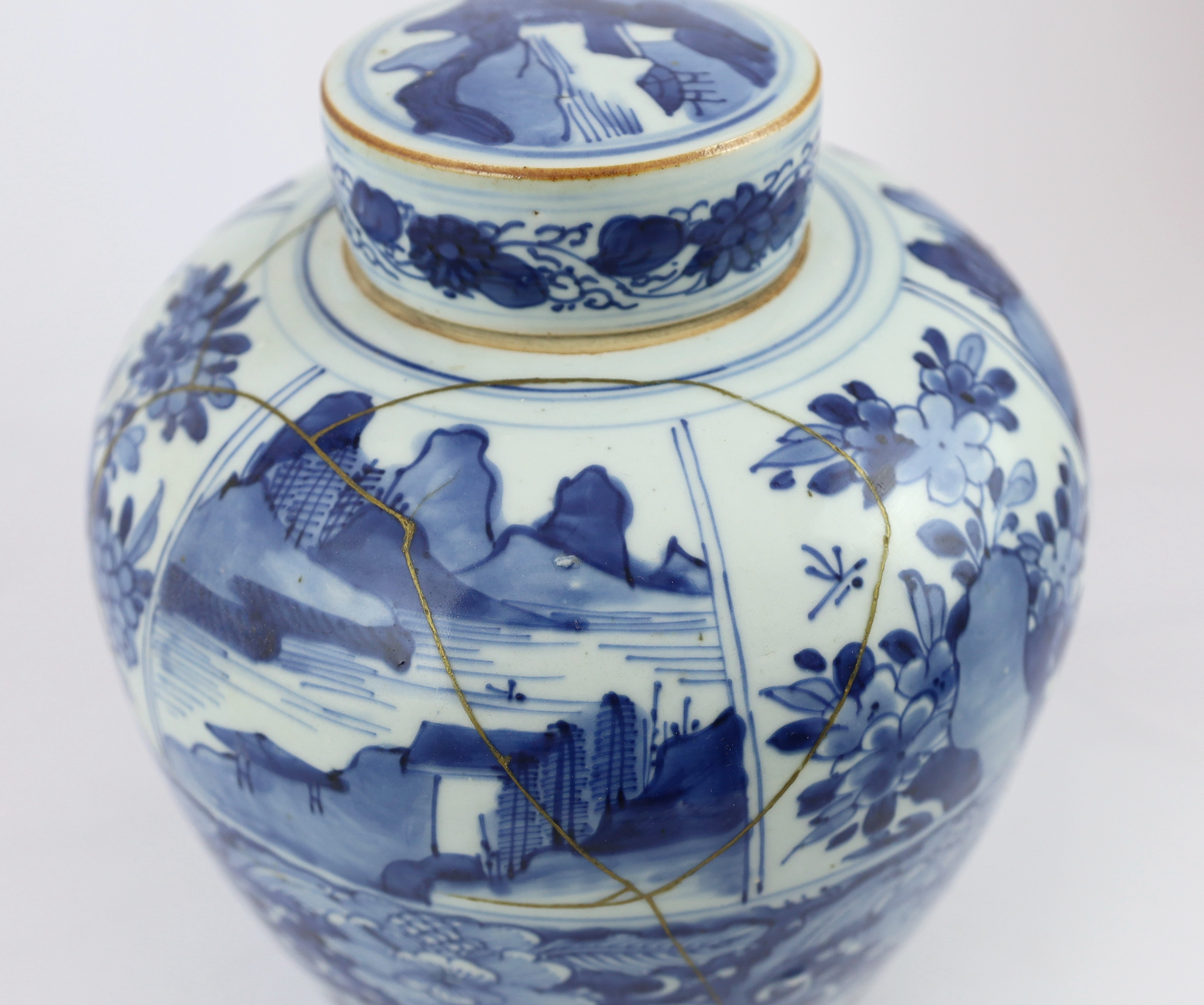 A Chinese blue and white ovoid jar and cover, Kangxi period, broken with kintsugi repair